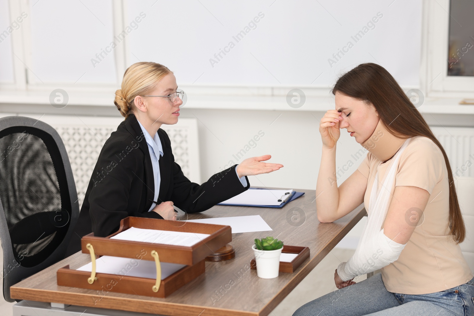 Photo of Injured woman having meeting with lawyer in office