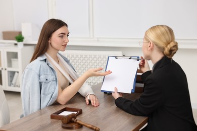 Photo of Injured woman having meeting with lawyer in office