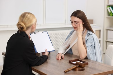 Photo of Injured woman having meeting with lawyer in office