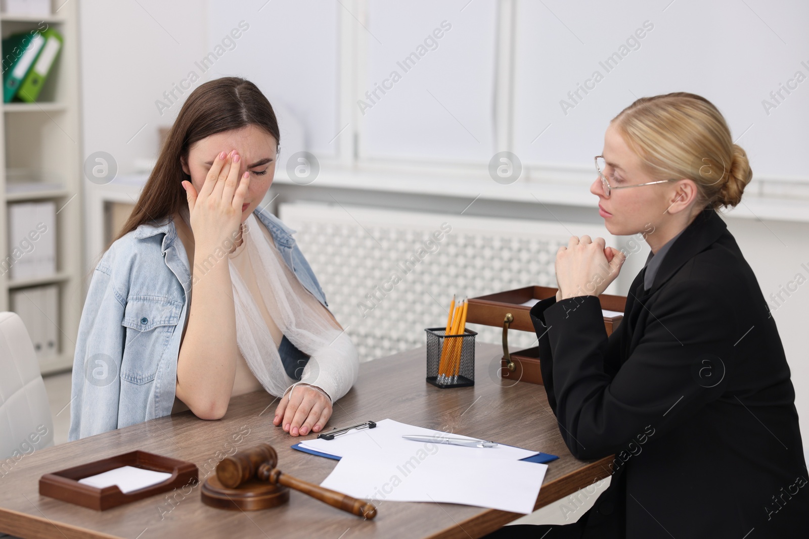 Photo of Injured woman having meeting with lawyer in office