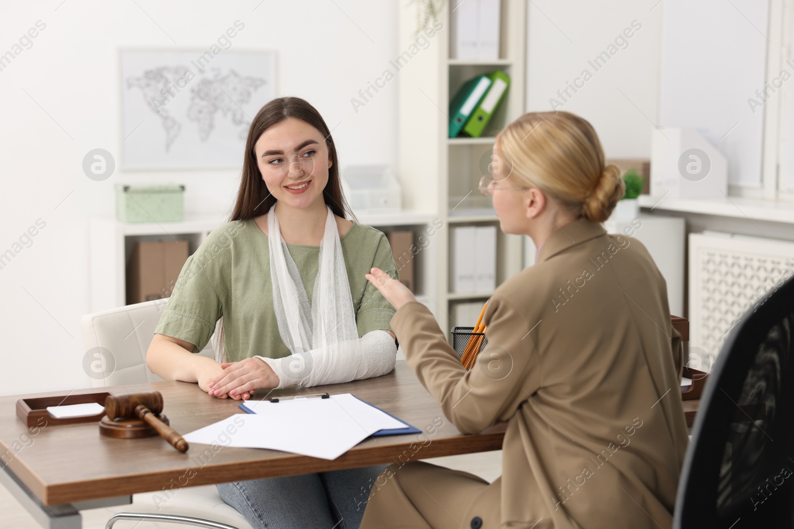 Photo of Injured woman having meeting with lawyer in office