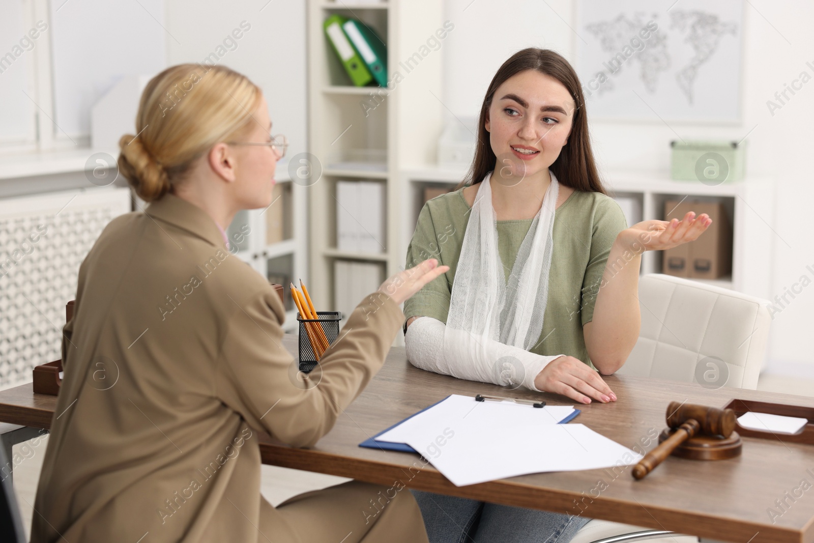 Photo of Injured woman having meeting with lawyer in office