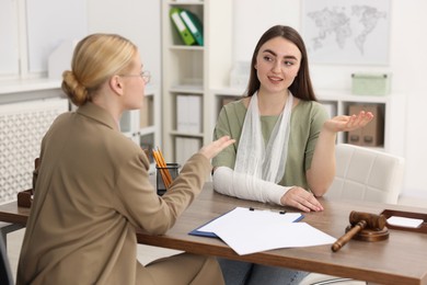 Photo of Injured woman having meeting with lawyer in office