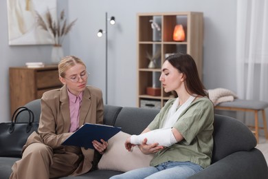 Photo of Injured woman having meeting with lawyer in office