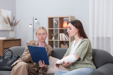 Photo of Injured woman having meeting with lawyer in office