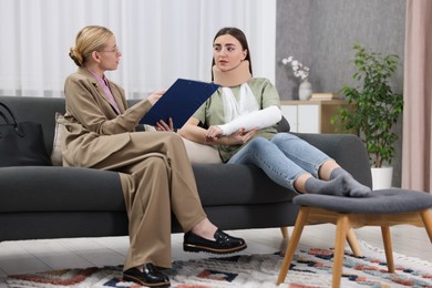 Photo of Injured woman having meeting with lawyer in office