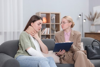 Photo of Injured woman having meeting with lawyer in office