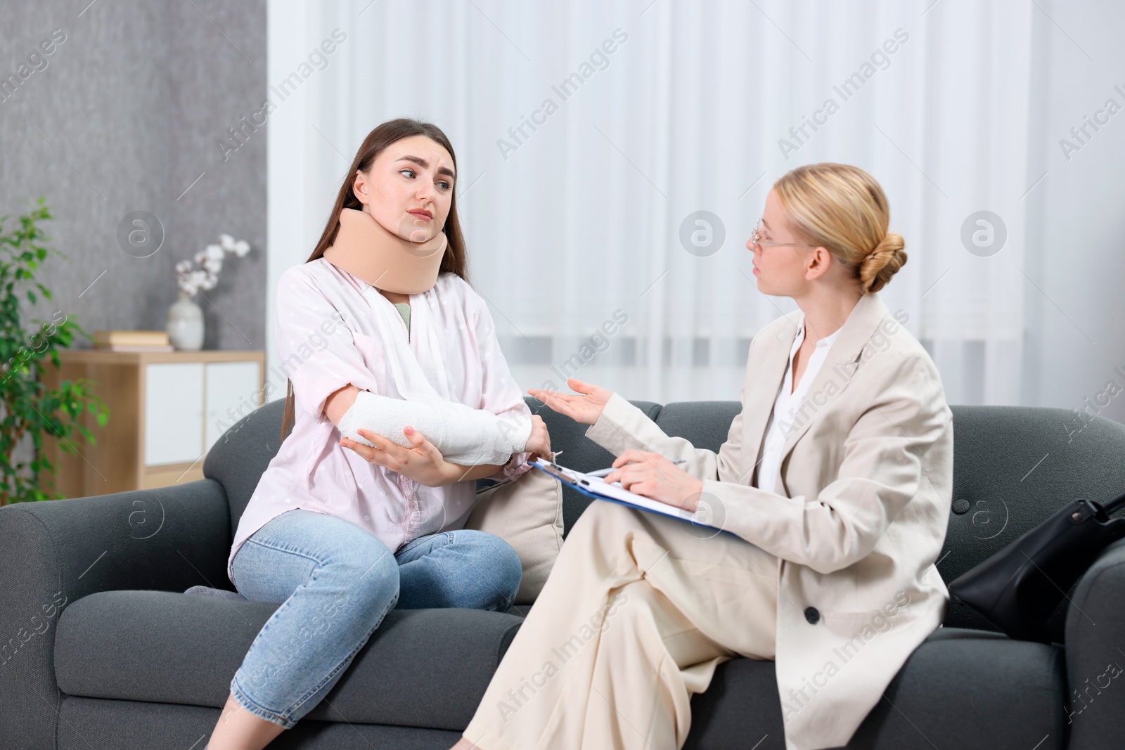 Photo of Injured woman having meeting with lawyer in office