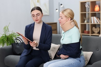 Photo of Injured woman having meeting with lawyer in office