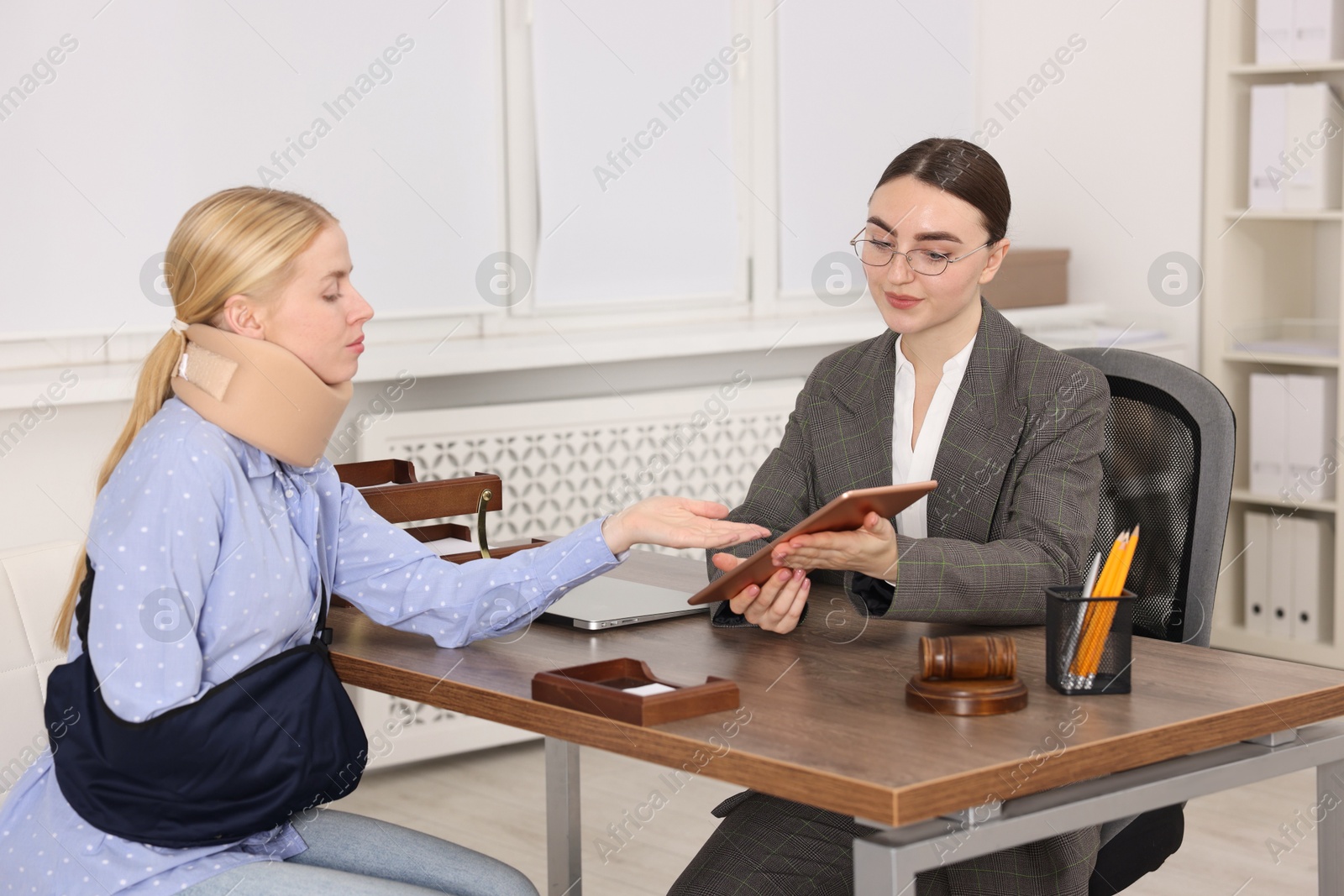 Photo of Injured woman having meeting with lawyer in office