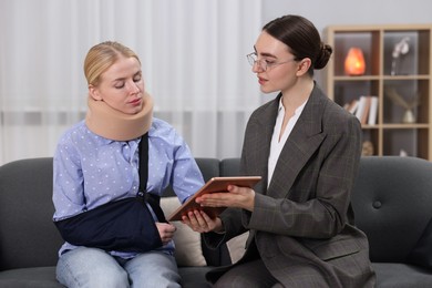 Photo of Injured woman having meeting with lawyer in office