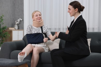 Photo of Injured woman having meeting with lawyer in office