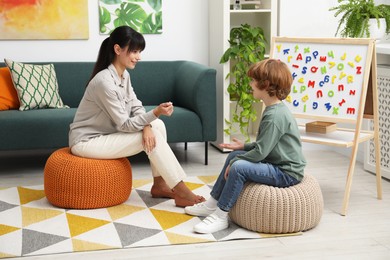 Photo of Psychologist having consultation with little boy in office