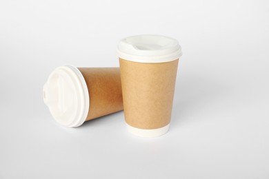 Photo of Paper cups with lids on white background. Mockup for design