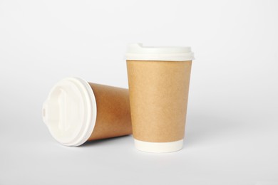 Photo of Paper cups with lids on white background. Mockup for design