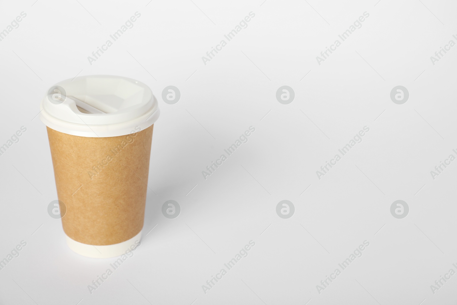 Paper cup with lid on white background. Mockup for design Photo of Paper cup with lid on white background. Mockup for design