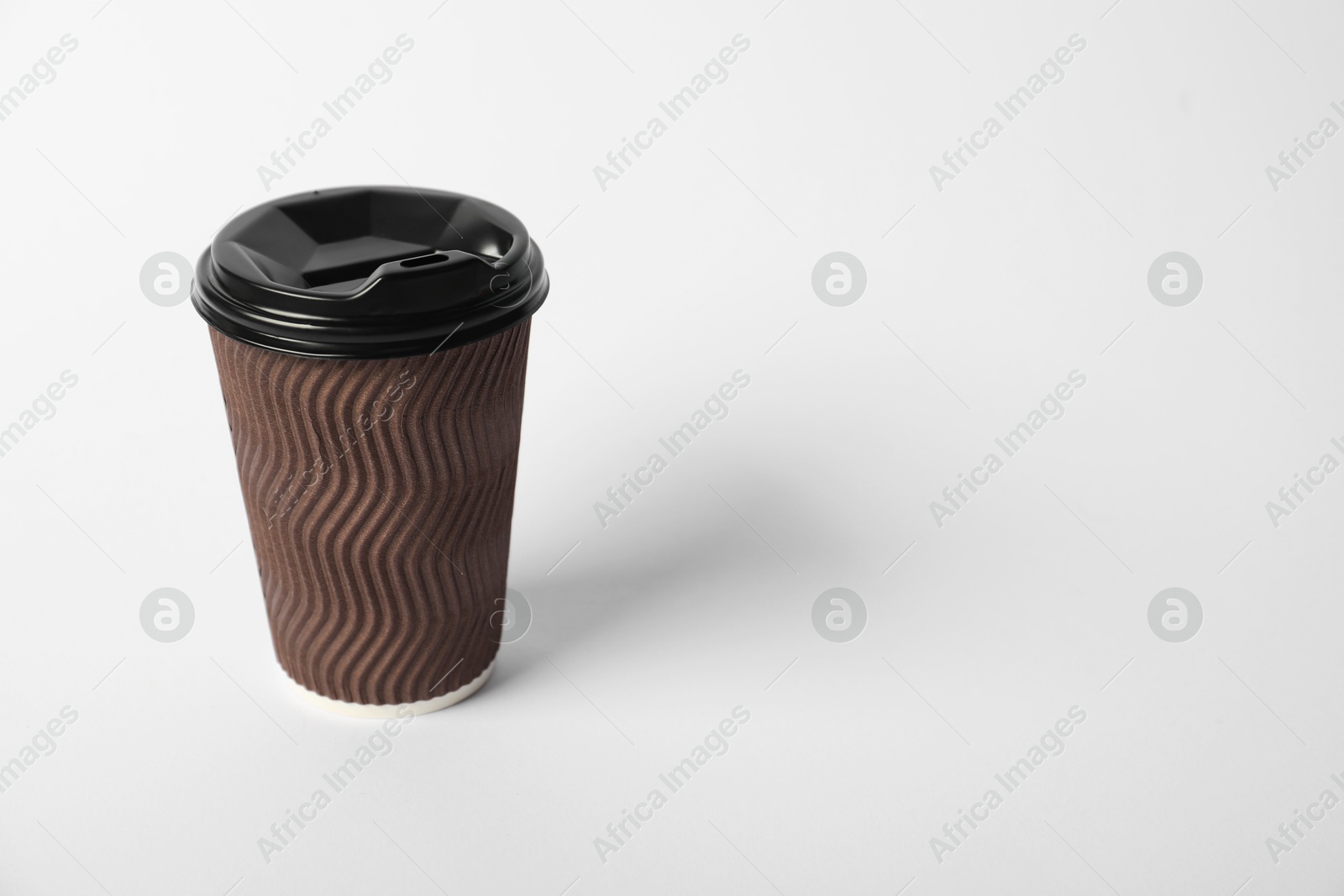 Paper cup with lid on white background. Mockup for design Photo of Paper cup with lid on white background. Mockup for design