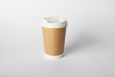 Photo of Paper cup with lid on white background. Mockup for design