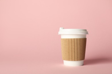Photo of Paper cup on pink background. Mockup for design