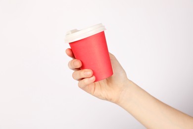 Photo of Woman holding paper cup on white background, closeup. Mockup for design