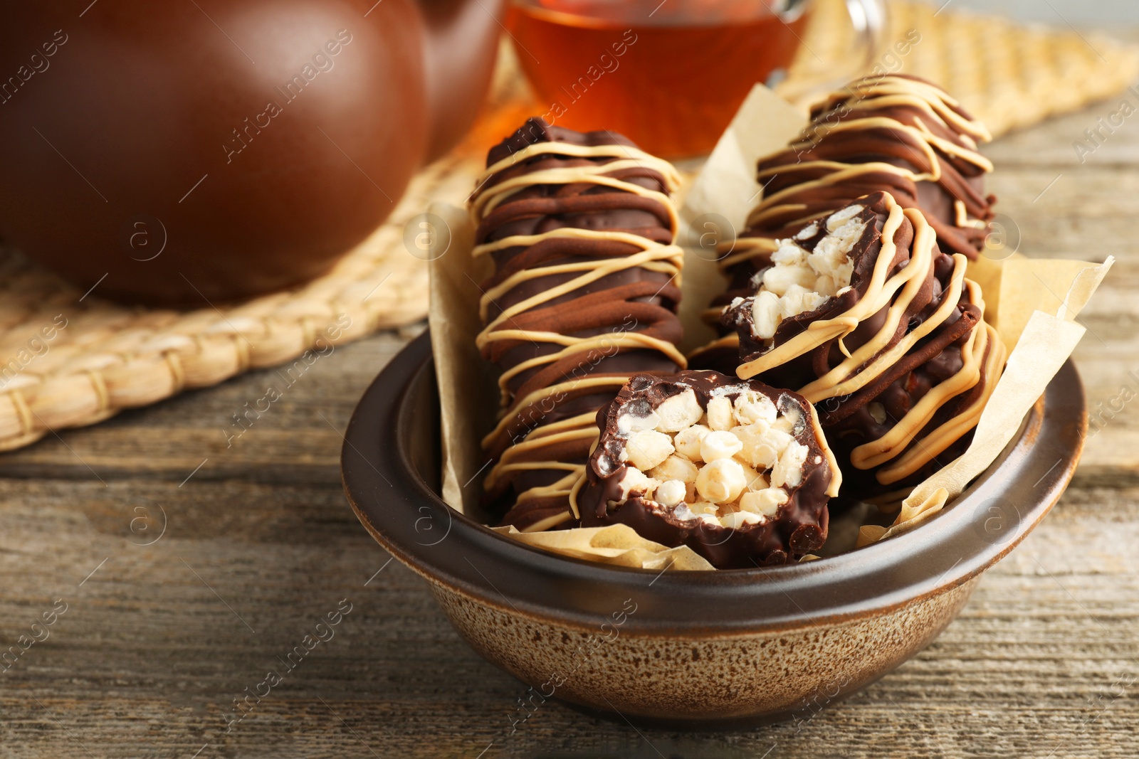 Photo of Delicious chocolate puffed rice bars on wooden table, closeup