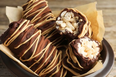 Photo of Delicious chocolate puffed rice bars on wooden table, closeup