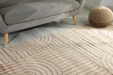 Photo of Stylish soft rug with pattern on floor in living room