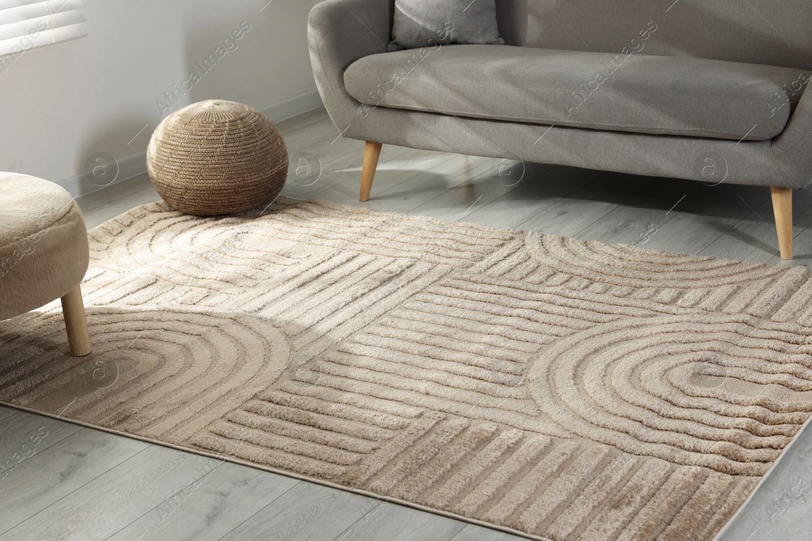 Stylish soft rug with pattern on floor in living room Photo of Stylish soft rug with pattern on floor in living room