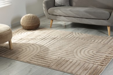 Photo of Stylish soft rug with pattern on floor in living room
