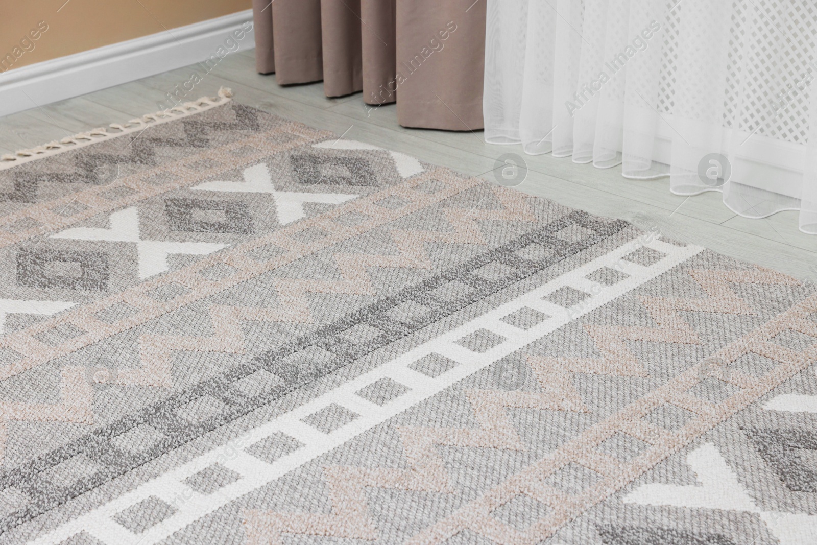 Stylish soft rug with pattern on floor indoors Photo of Stylish soft rug with pattern on floor indoors