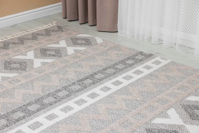 Photo of Stylish soft rug with pattern on floor indoors