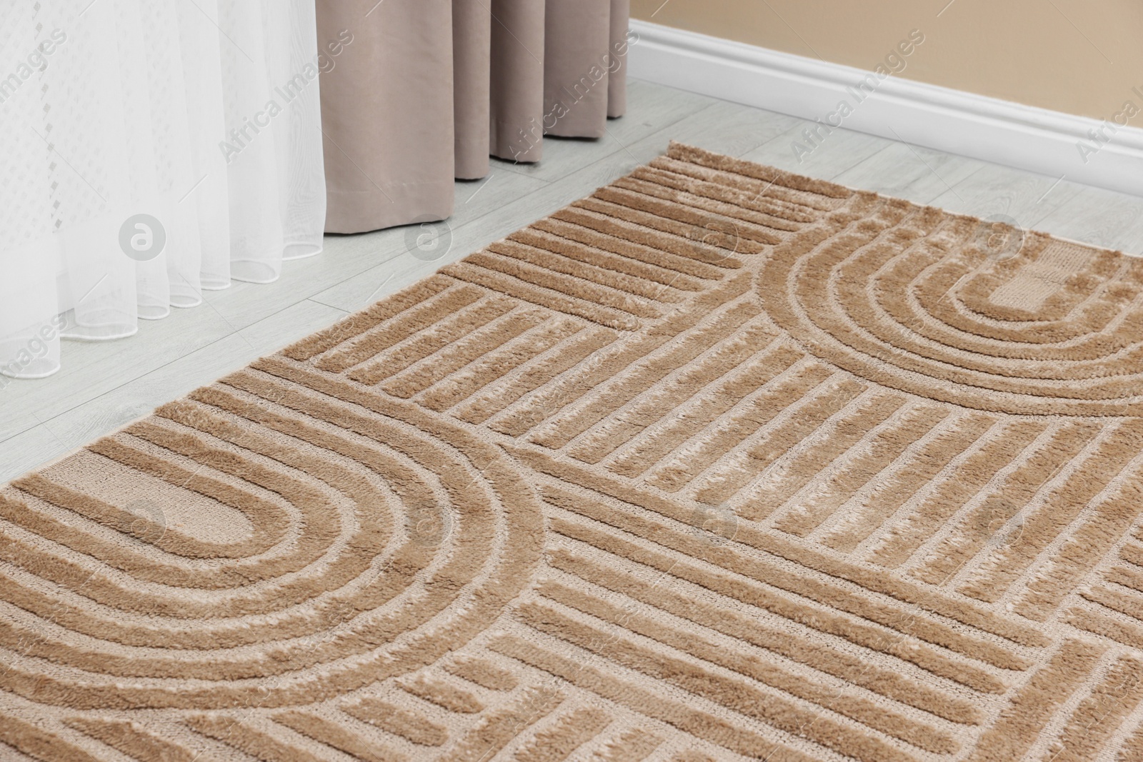 Stylish soft rug with pattern on floor indoors, closeup Photo of Stylish soft rug with pattern on floor indoors, closeup