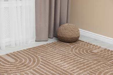 Photo of Stylish soft rug with pattern on floor indoors