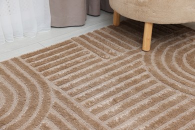 Photo of Stylish soft rug with pattern on floor indoors, closeup