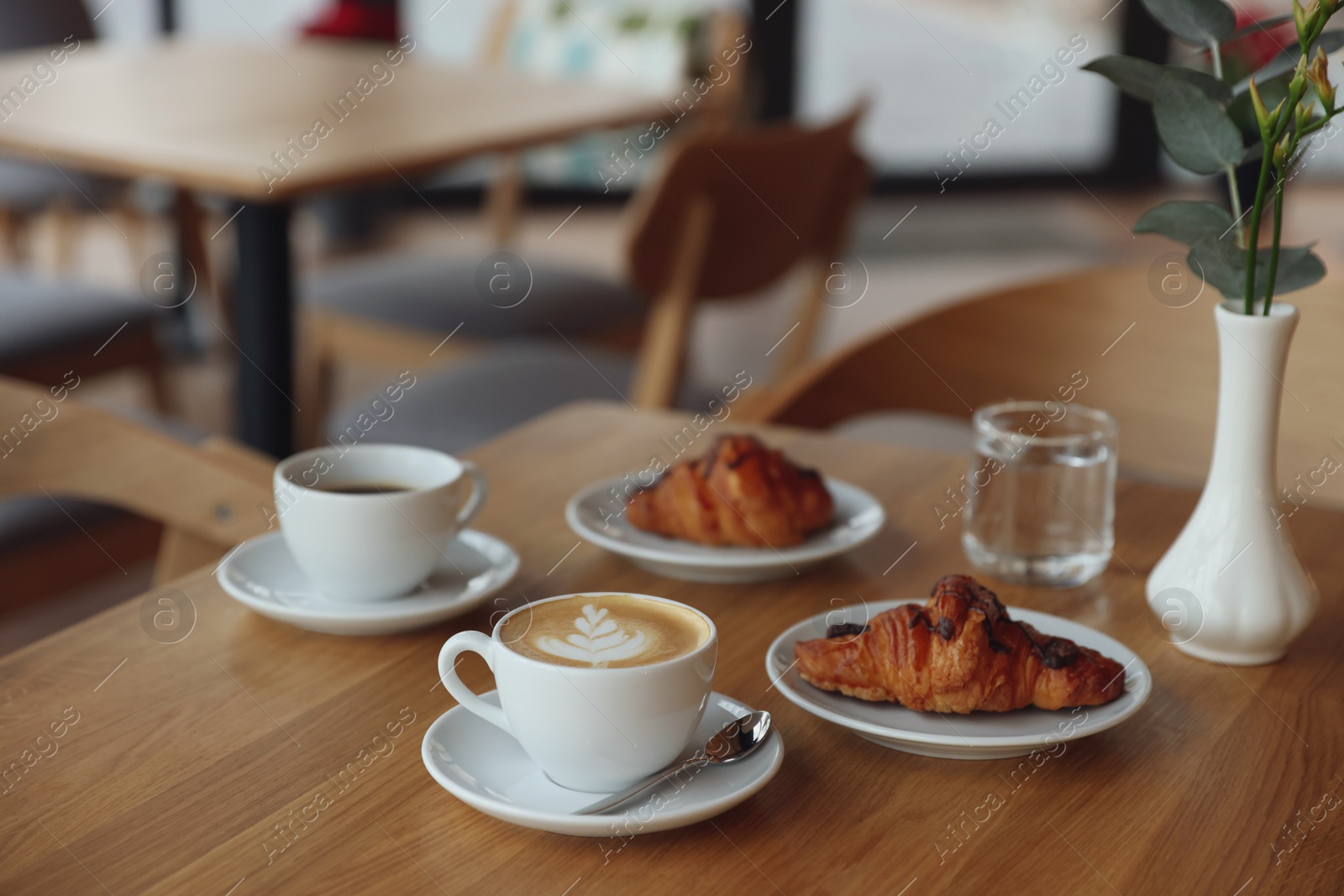 Photo of Delicious breakfast served on wooden table in cafe