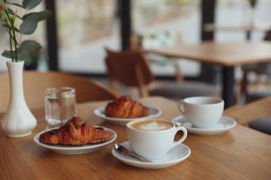 Photo of Delicious breakfast served on wooden table in cafe