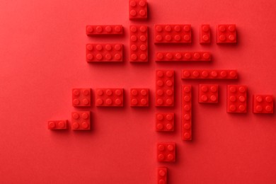 Photo of Construction toy. Building bricks on red background, flat lay