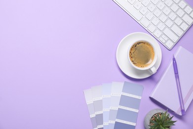 Photo of Designer's workplace with keyboard, stationery and cup of coffee on lilac background, flat lay. Space for text