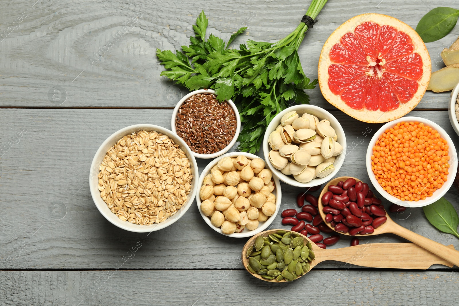 Photo of Superfood. Different healthy food products on grey wooden table, flat lay