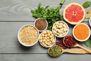 Photo of Superfood. Different healthy food products on grey wooden table, flat lay