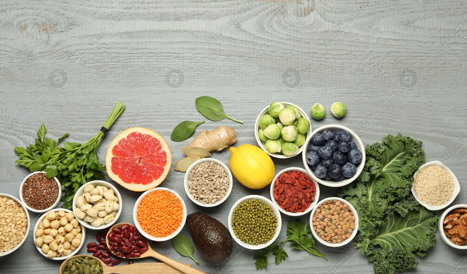 Photo of Superfood. Different healthy food products on grey wooden table, flat lay