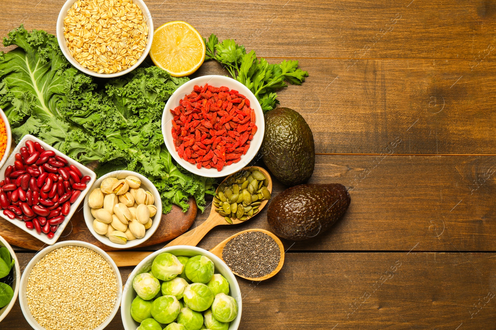 Photo of Superfood. Different healthy food products on wooden table, flat lay. Space for text