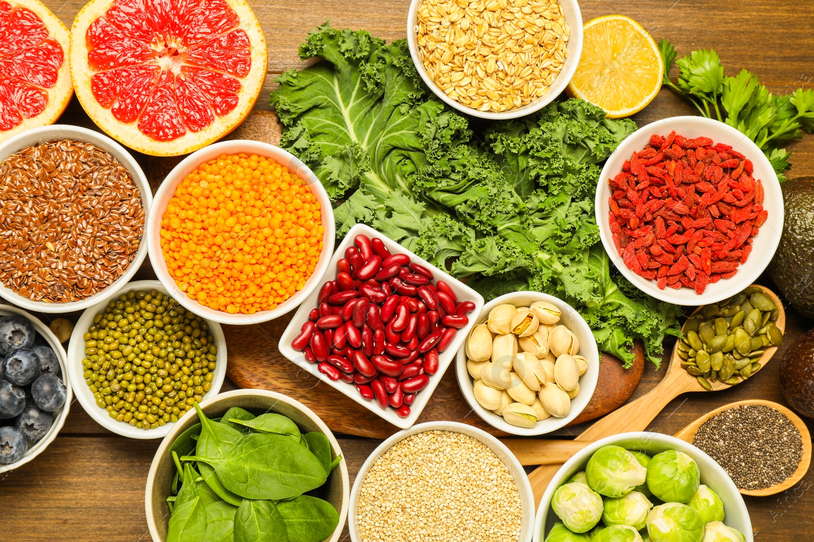 Photo of Superfood. Different healthy food products on wooden table, flat lay