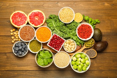 Photo of Superfood. Different healthy food products on wooden table, flat lay