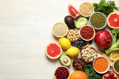 Photo of Different superfood products on white table, flat lay. Space for text