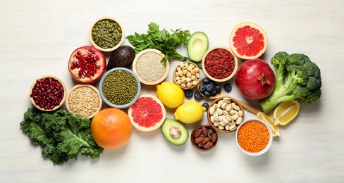 Photo of Different superfood products on white table, flat lay