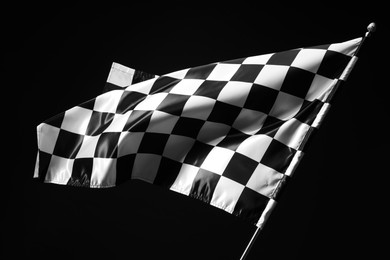 Photo of One racing checkered flag on black background