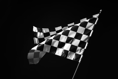 Photo of One racing checkered flag on black background