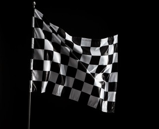 Photo of One racing checkered flag on black background