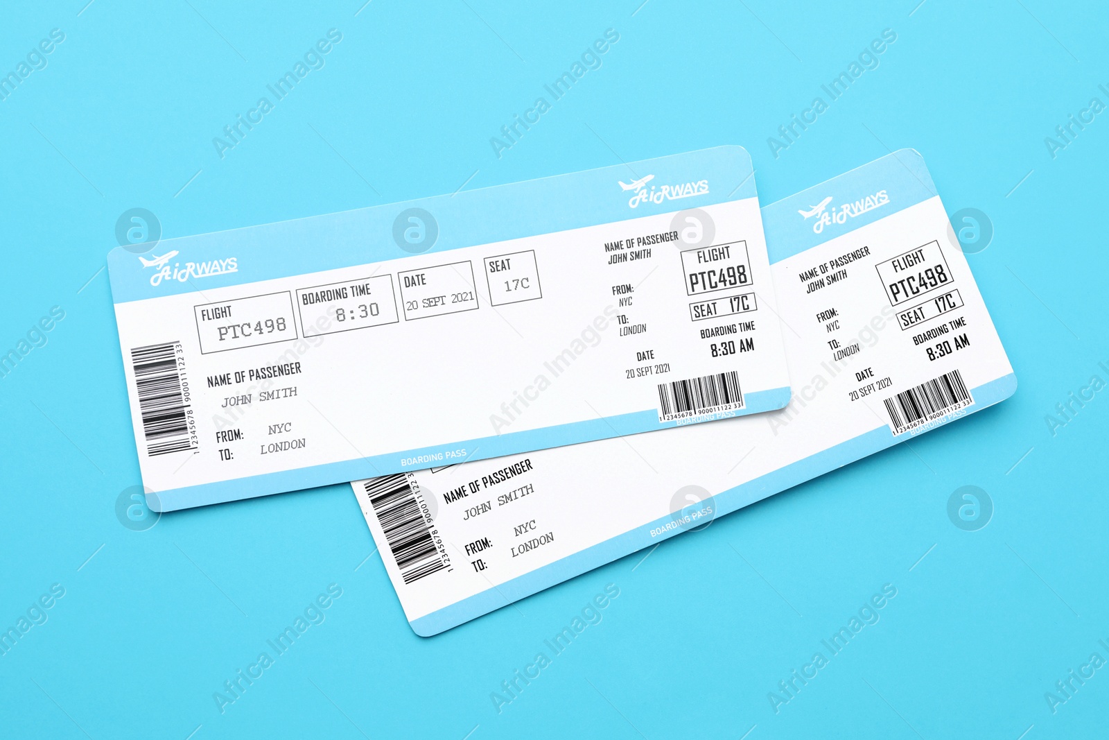 Photo of Travel agency. Flight tickets on light blue background, top view